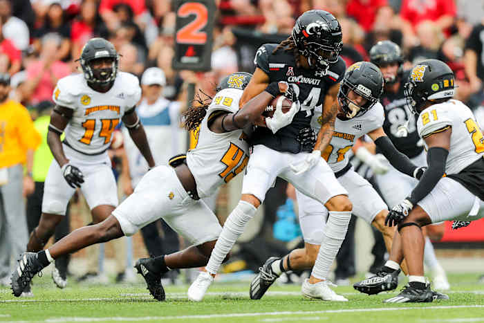 Sep 10, 2022; Cincinnati, Ohio, USA; Cincinnati Bearcats wide receiver Nick Mardner (84) runs with the ball against Kennesaw State Owls linebacker Juandarion Silas (49) in the second half at Nippert Stadium. Mandatory Credit: Katie Stratman-USA TODAY Sports